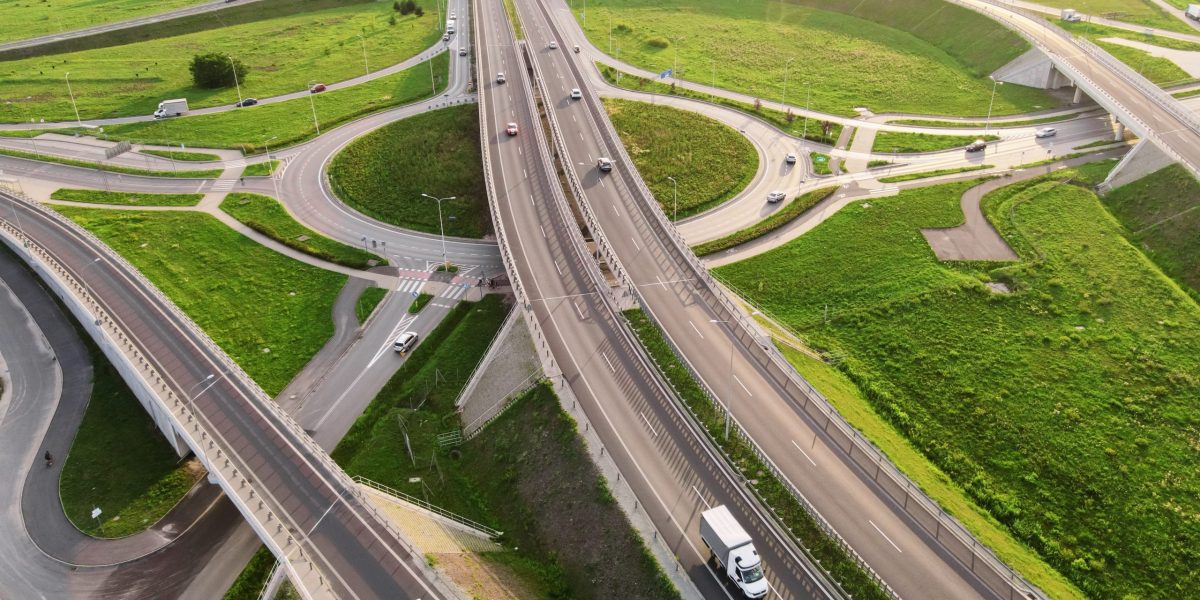 Aerial,View,Of,Cars,Driving,On,Round,Intersection,In,City,